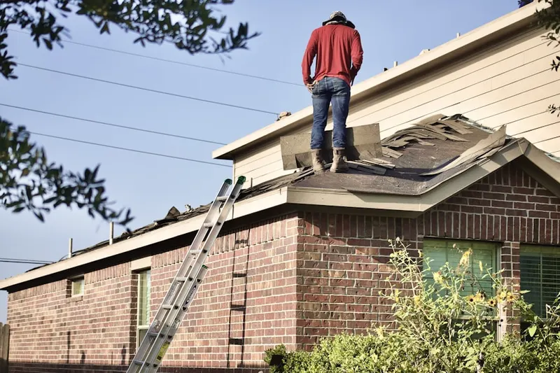 Professional roofer working on a residential roof in Guadalupe